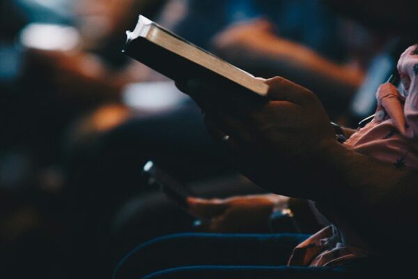 Photo by Kevin Wright a person holding a book in their hands
